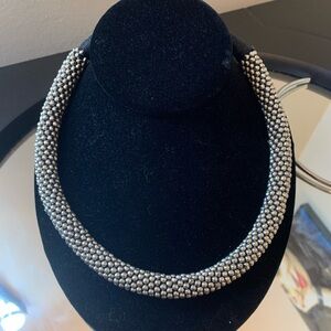 Silver coloured choker in black rope type choker